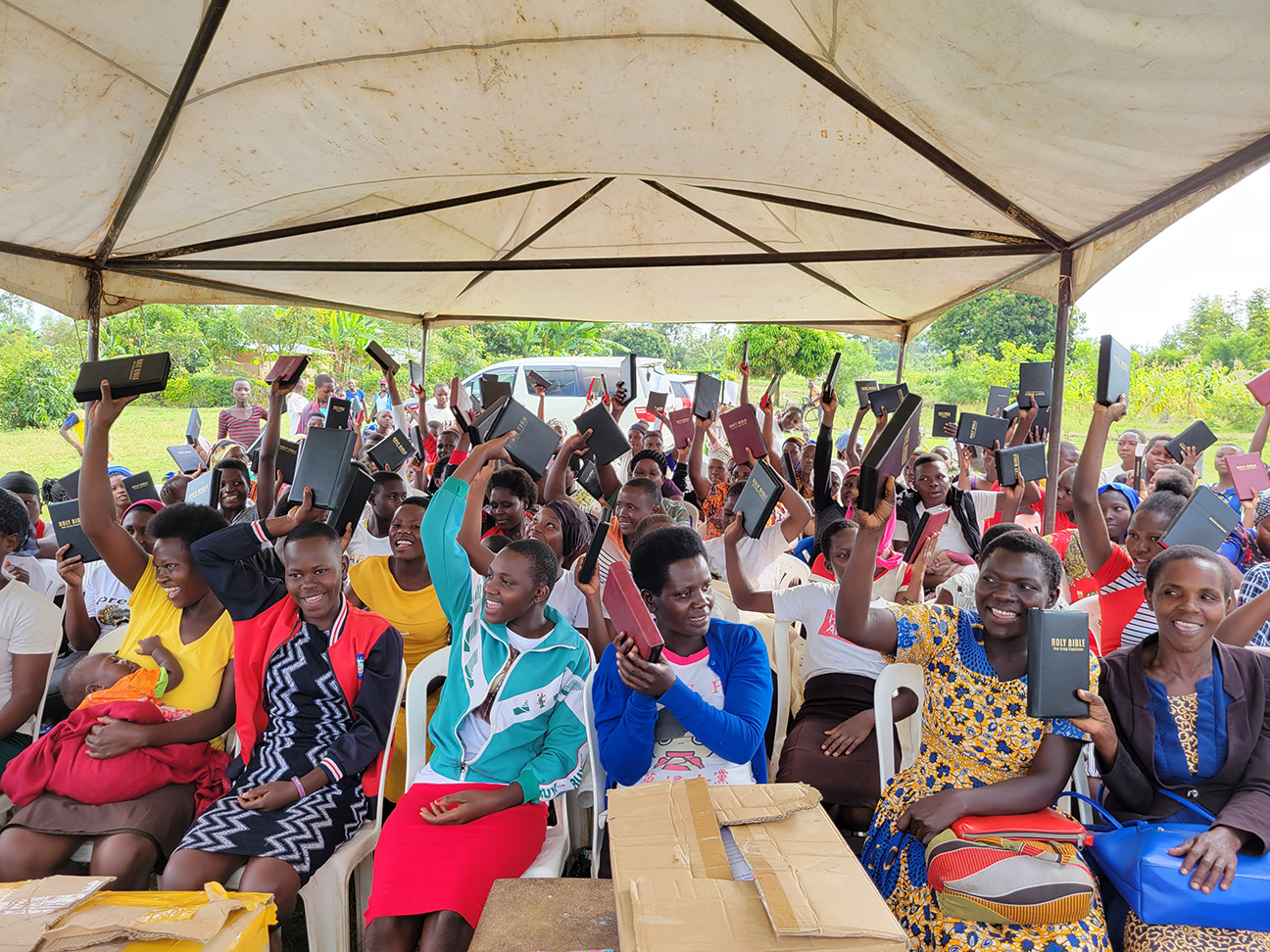 Women waving their new Bibles in the air